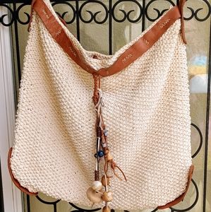 Stunning Lucky crochet cream mailbag with saddle leather accents. Snap closure.